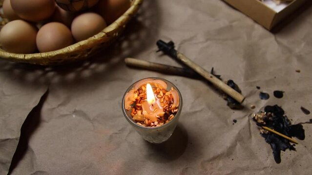 Lightning candle, flame. Preparing for painting Ukrainian Easter eggs decorated with folk designs using a wax resist method. Easter egg. Graphic folk sketch. Wax tool