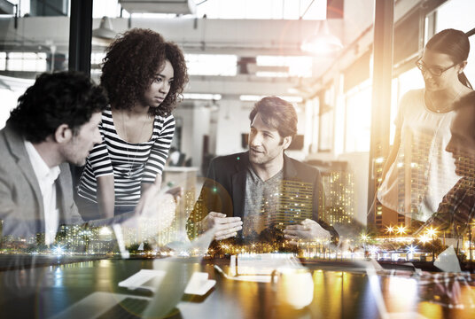 Theyre the best in the city. Multiple exposure shot of a business meeting superimposed over a city.