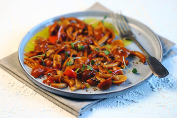 Selective focus. Marinated oyster mushrooms on a plate with olive oil.