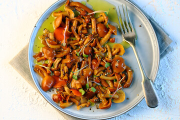 Selective focus. Marinated oyster mushrooms on a plate with olive oil.