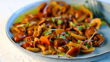 Selective focus. Marinated oyster mushrooms on a plate with olive oil.