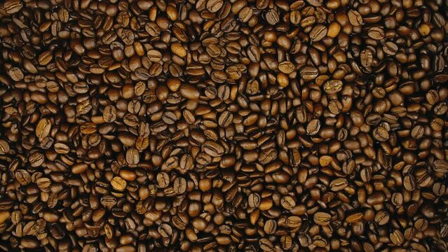 The coffee beans on the turntable. The coffee beans spin rotate. Twist, create pattern, make design picture.