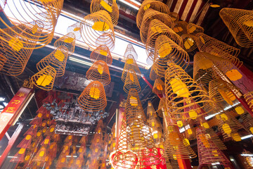 China round incense are burning inside the Ong temple in Can Tho
