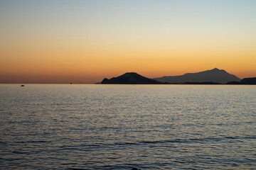 Naklejka na ściany i meble Sunset at sea. Sea landscape. Variety of colors and hues of the sun. Bagnoli, Naples, Italy.