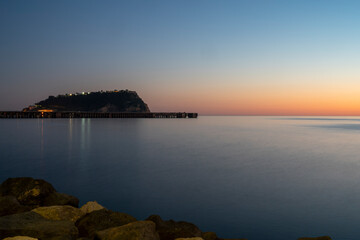 Fototapeta premium Sunset at sea. Sea landscape. Variety of colors and hues of the sun. Bagnoli, Naples, Italy.