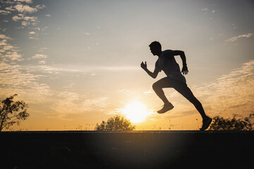 Young man running in the city. Healthy lifestyle concept. Young fitness man runner athlete running at park. Athlete runner feet running on road, Jogging concept at outdoors. Man running for exercise.