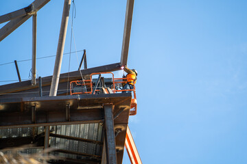 A welder with protective mask welding metal. Worker welding parts of steel construction. 