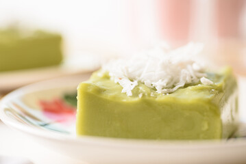 Pandanus pudding with coconut topping on white background, Traditional sweets that are cultural heritage of Asia.