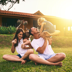They have the most fun as a family. Shot of a happy family bonding together outdoors.
