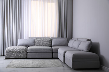 Large grey sofa in living room. Interior design