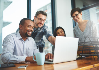 Working together to get the task done. Shot of businesspeople working together in the office.