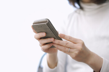 スマートフォンでテキスト入力をするアジア人の女性	