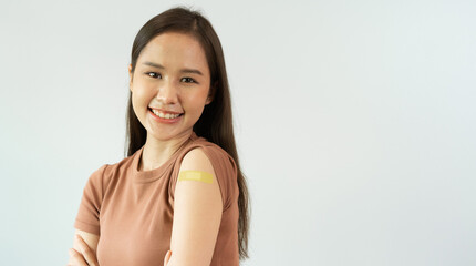 Asian woman smiling brightly happy vaccination Show arms with bandages. The government campaigns for people to vaccinate against COVID-19. get vaccine Coronavirus