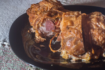 stuffed chicken rolls roast placed on a black plate,copy space left
