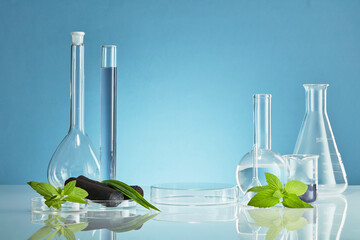 Activated charcoal research in laboratory with glassware beaker and transparent podium with green...