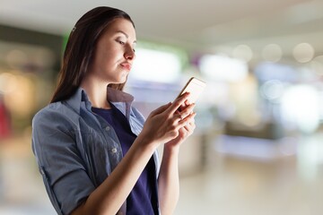 University student. Mobile phone reading. Sitting outdoors.