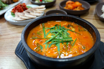 eat chives on top of spicy korean style blood sausage soup.