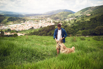 The best way to spend a day. Full length shot of a handsome young man walking with his golden...