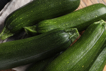 Many raw ripe zucchinis on table, closeup