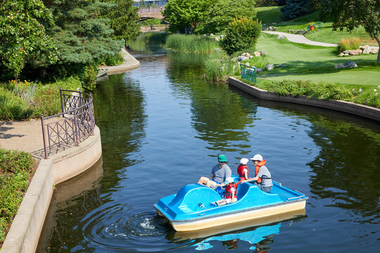 Family on a paddleboat enjoying a water activity on a sunny summer day