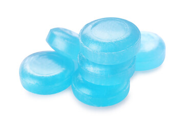 Many light blue cough drops on white background