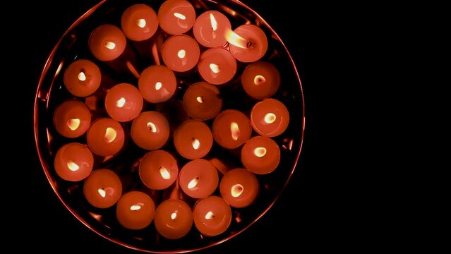 lighted flickering candles in plat for decoration on the occasion of diwali from top angle