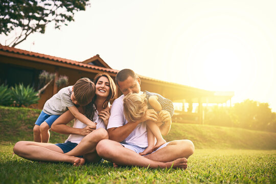 Every Moment Spent Together Is Absolute Bliss. Shot Of A Happy Family Bonding Together Outdoors.