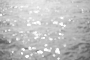 Black and white blur bokeh on sea water with over light. light glow abstract background free space. nature landscape backdrop. card or poster couple problem, sad or broken heart concept