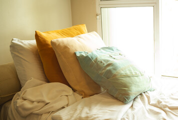 Over light from window with Cushions on bed. interiors bedroom in luxury hotel. furniture style modern in vacation holidays. tropical travel summer concept.