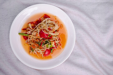 Papaya salad Thailand. spicy food traditional of asian Thai. ingredient bitter, tomato, lemon or lime,vegetable and spices. food for diet good health concept. flat lay with close up.