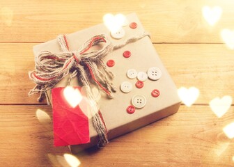 Vintage gift box with a blank gift tag on a wooden desk.
