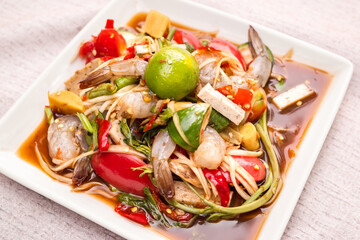 Papaya salad Thailand. spicy food traditional of asian Thai.ingredient bitter, tomato, lemon or lime,fresh shrimp, pickled fish,vegetable and spices. food for diet good health concept.