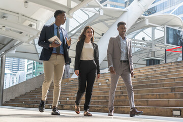 Group of business people.Business people meeting talking and sharing their ideas in city. Business team and teamwork concept. Business people standing outside in the city discussing about new project.