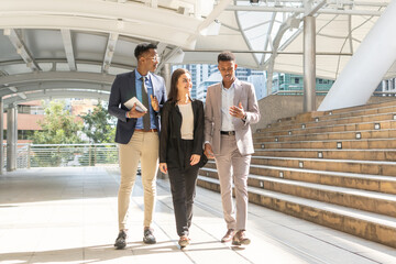 Group of business people.Business people meeting talking and sharing their ideas in city. Business team and teamwork concept. Business people standing outside in the city discussing about new project.