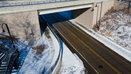 City street with bridge and snow