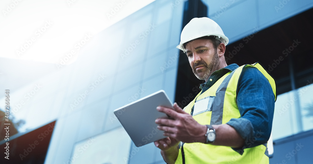 Poster This software help me to keep track of everything. Shot of a engineer using a digital tablet on a construction site.