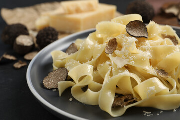 Tasty tagliatelle with truffle on table, closeup