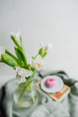 selective focus bouquets white tulips with green stems. . in the cozy atmosphere. spring mood, floral content