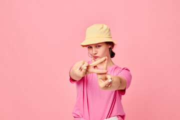 attractive young woman fashion clothes hat pink t-shirt decoration posing Studio