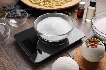 Handmade bath bombs and ingredients on wooden table