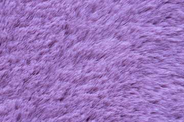 Pantone Color 2022 Very Peri. Light lavender long fiber soft fur. purple fur for background or texture. Fuzzy pink fur plaid. Shaggy background. Fluffy fake textile fur. selective focus. copy space