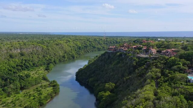 Altos de Chavon village on cliff overlooks river, La Romana; aerial push in