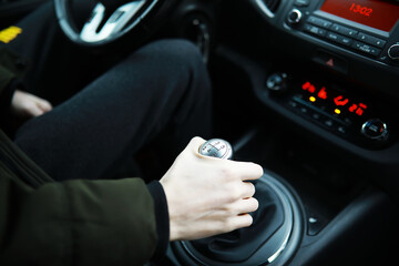 Fototapeta premium Hand on the car gear knob. The driver switches the speed in the car. Hand on gear lever.