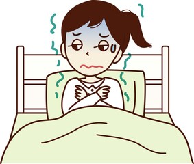 ベッドに入り、悪寒がする顔色の悪い若い女性。