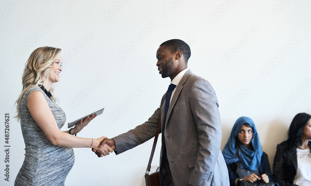 Poster its so good to finally meet you. shot of a well-dressed candidate shaking hands with his interviewer