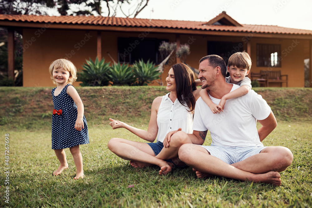 Wall mural Our kids brighten all our days. Shot of a happy family bonding together outdoors.