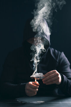 Drug addict man or drug dealer prepares heroin.