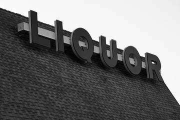 Black and white photo of liquor store sign
