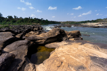 Mekong river showing rock formations formed by water erosion over thousands of years showing more often due to water low levels