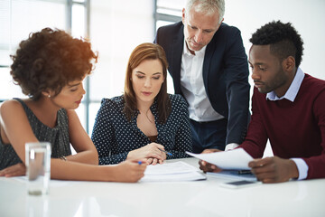 Working with their ideas. Cropped shot of corporate businesspeople in the boardroom.